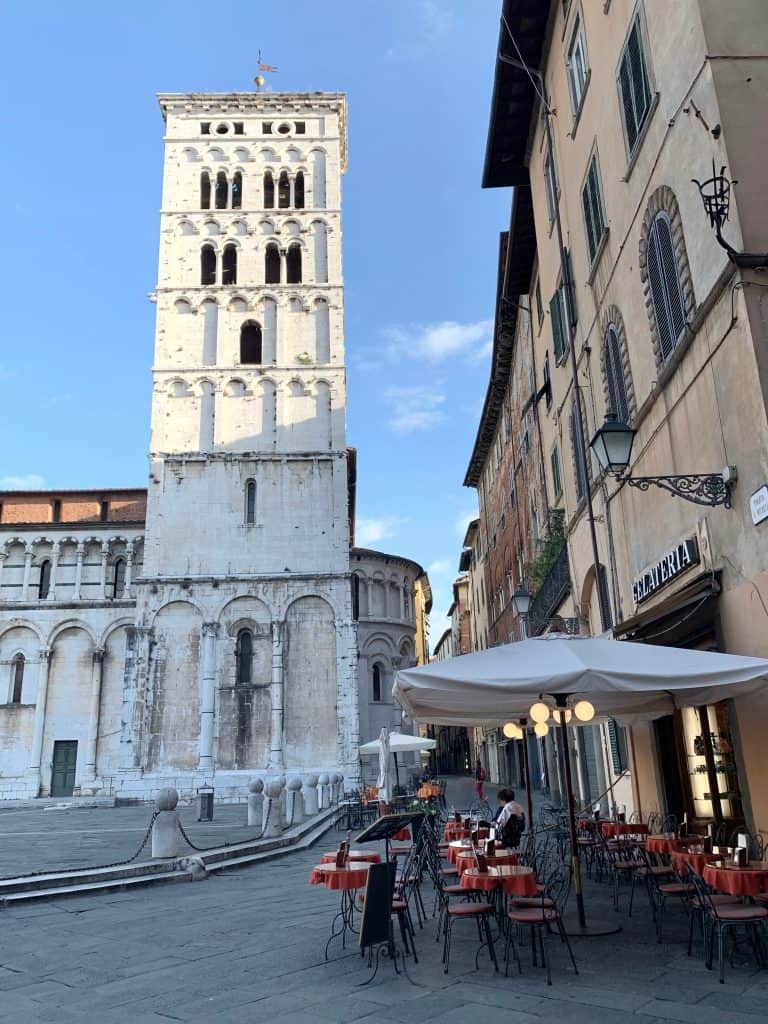 Piazza San Michele with cafes and tower of Chiesa di San Michele in Foro