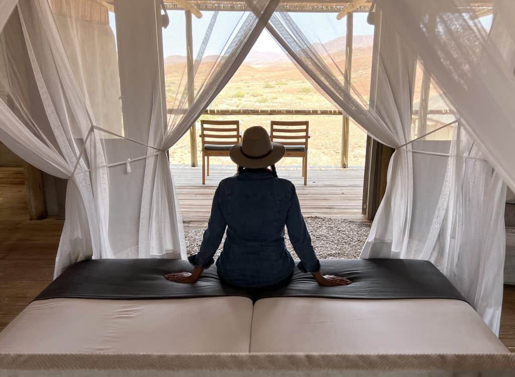 Eco-friendly Lodges in Namibia: Damaraland Camp bedroom looking out to wilderness
