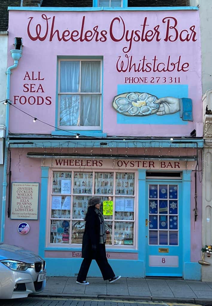 Whitstable Oyster Company Pink Exterior with bejal walking past outside