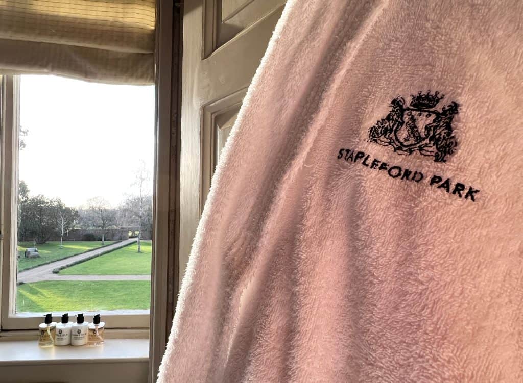 White bathrobe in bathroom of Baker Suite with Noble Isle toiletries in the background
